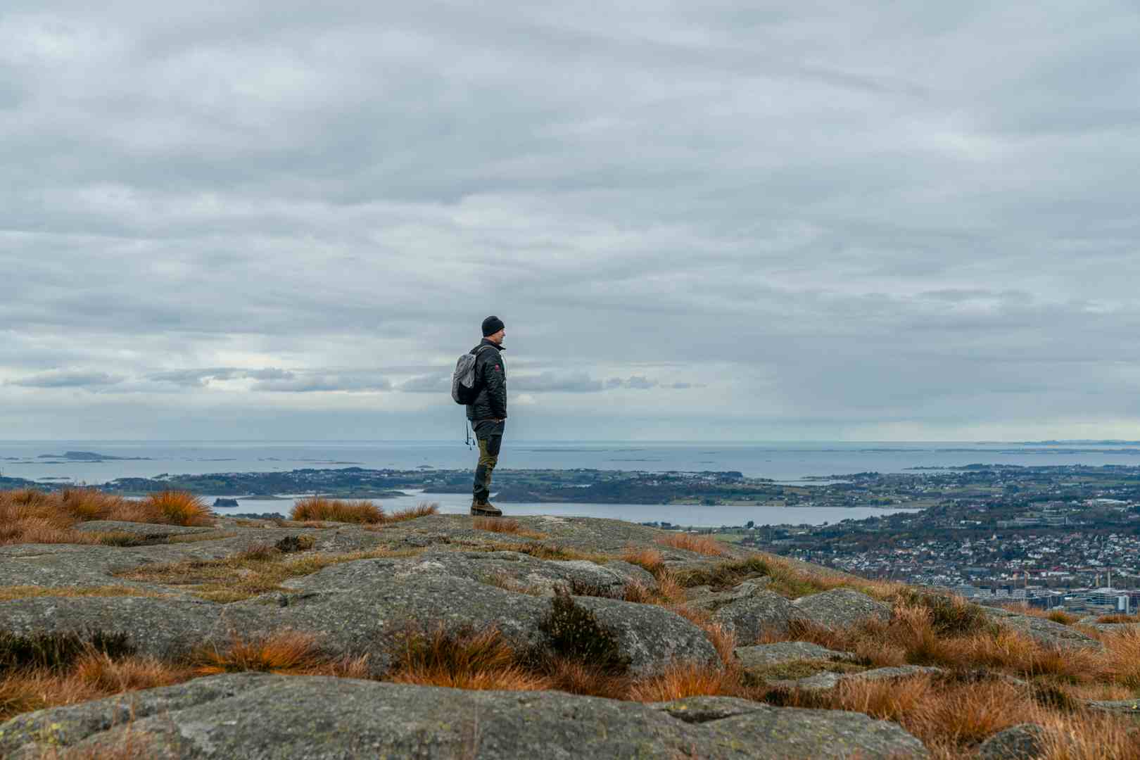 Man watching a waterfall in scenic surroundings in Norway