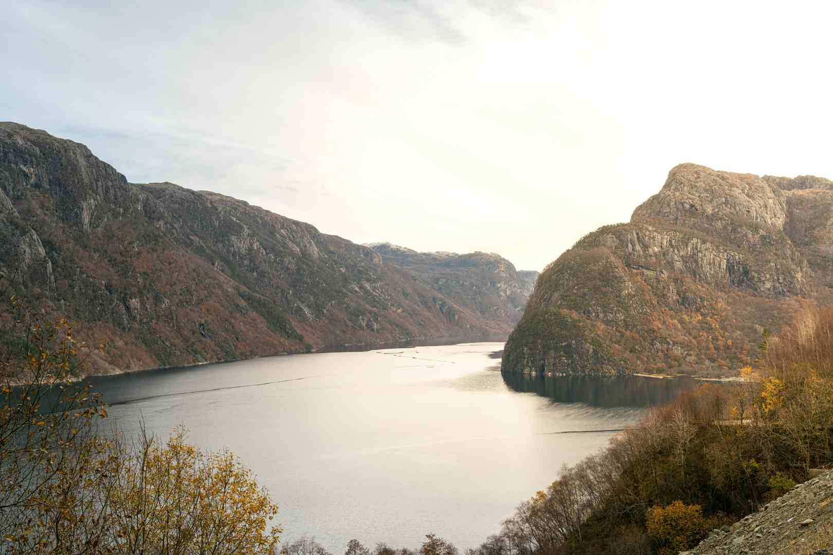 Man watching a waterfall in scenic surroundings in Norway