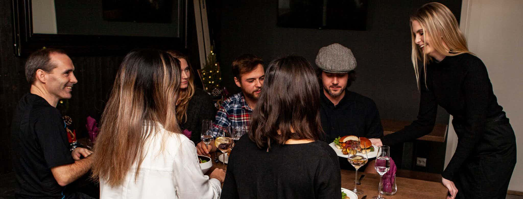 people eating at restaurant and plates of food