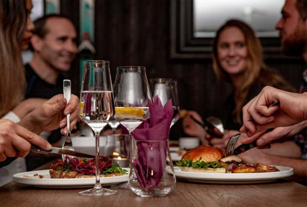 people eating at restaurant and plates of food