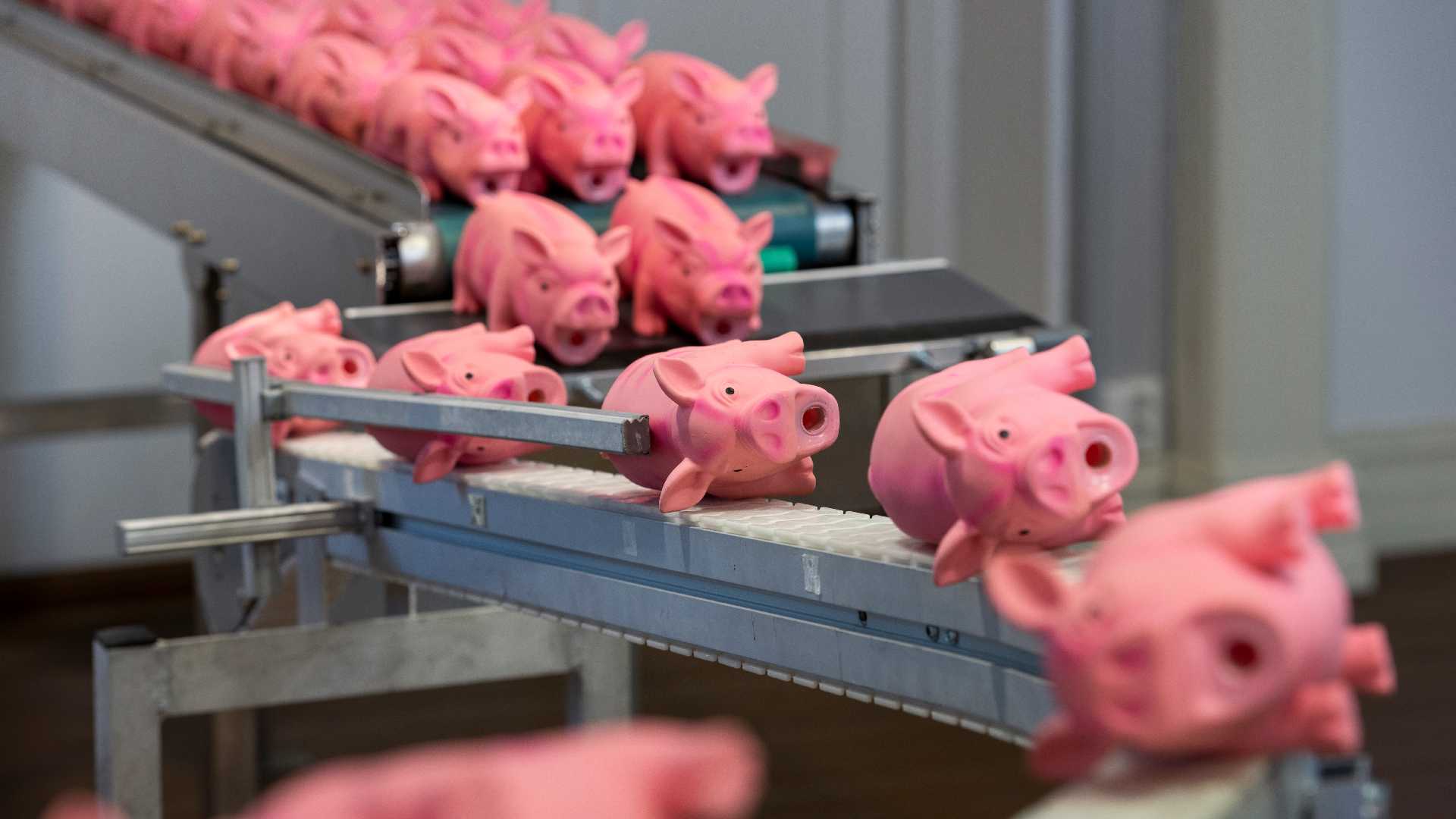 Pink rubber pigs on an assembly line